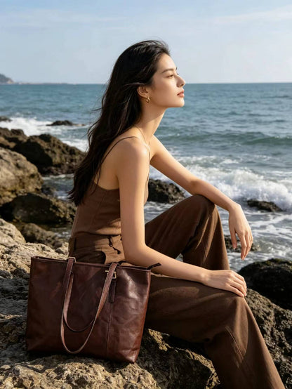 Tall genuine leather tote with a structured profile for carrying office essentials.