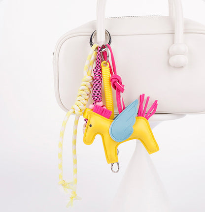 Vibrant pony handbag accent attached to a structured leather tote