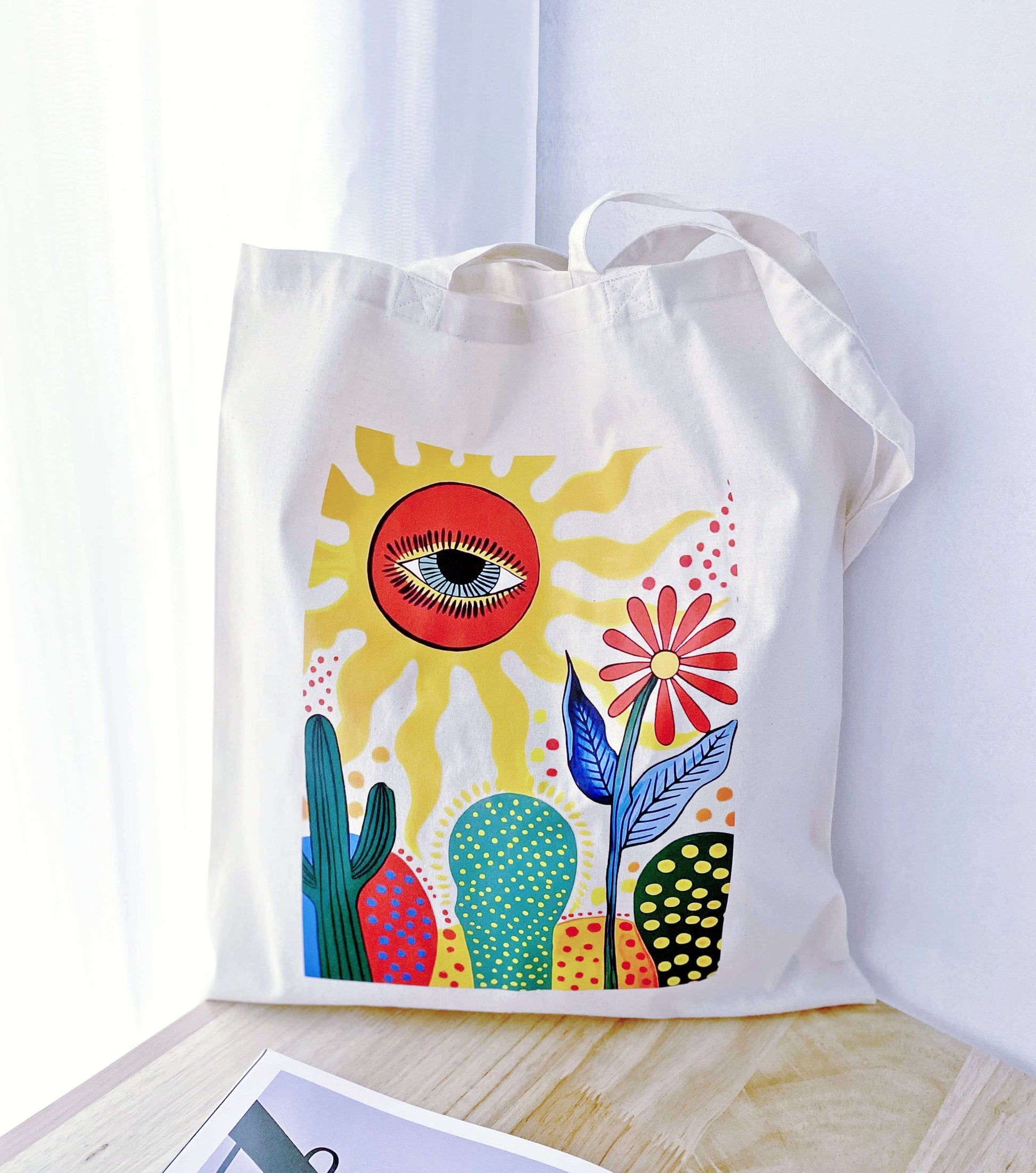 The tote holding a bottle of wine and a baguette, illustrating a chic and reusable hostess gift idea for the next dinner party invitation.