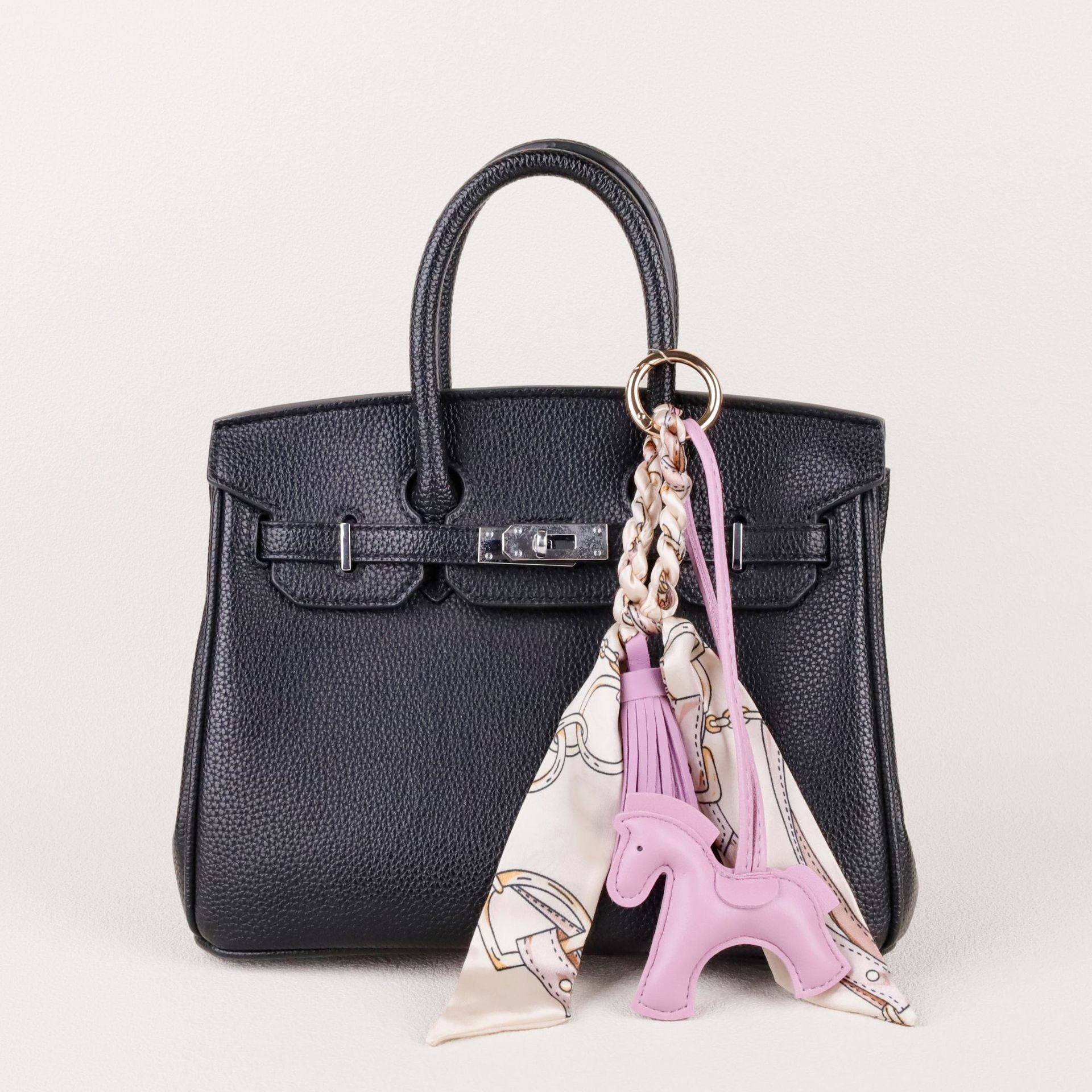 Playful horse accessory clipped onto a leather tote