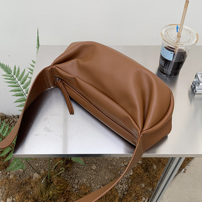 Ergonomic shoulder bag with wide non-slip strap for jacket wear