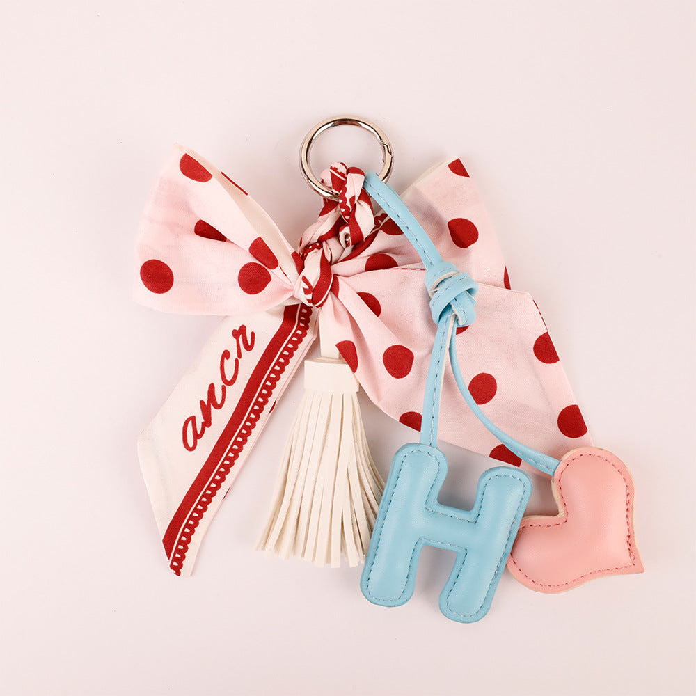 Polka dot fabric and bow detail on a pink keychain