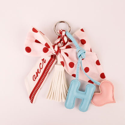 Polka dot fabric and bow detail on a pink keychain