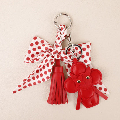 Red tassel keychain with a polka dot bow accent
