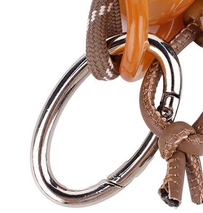 Character-inspired woven charm for a favorite handbag