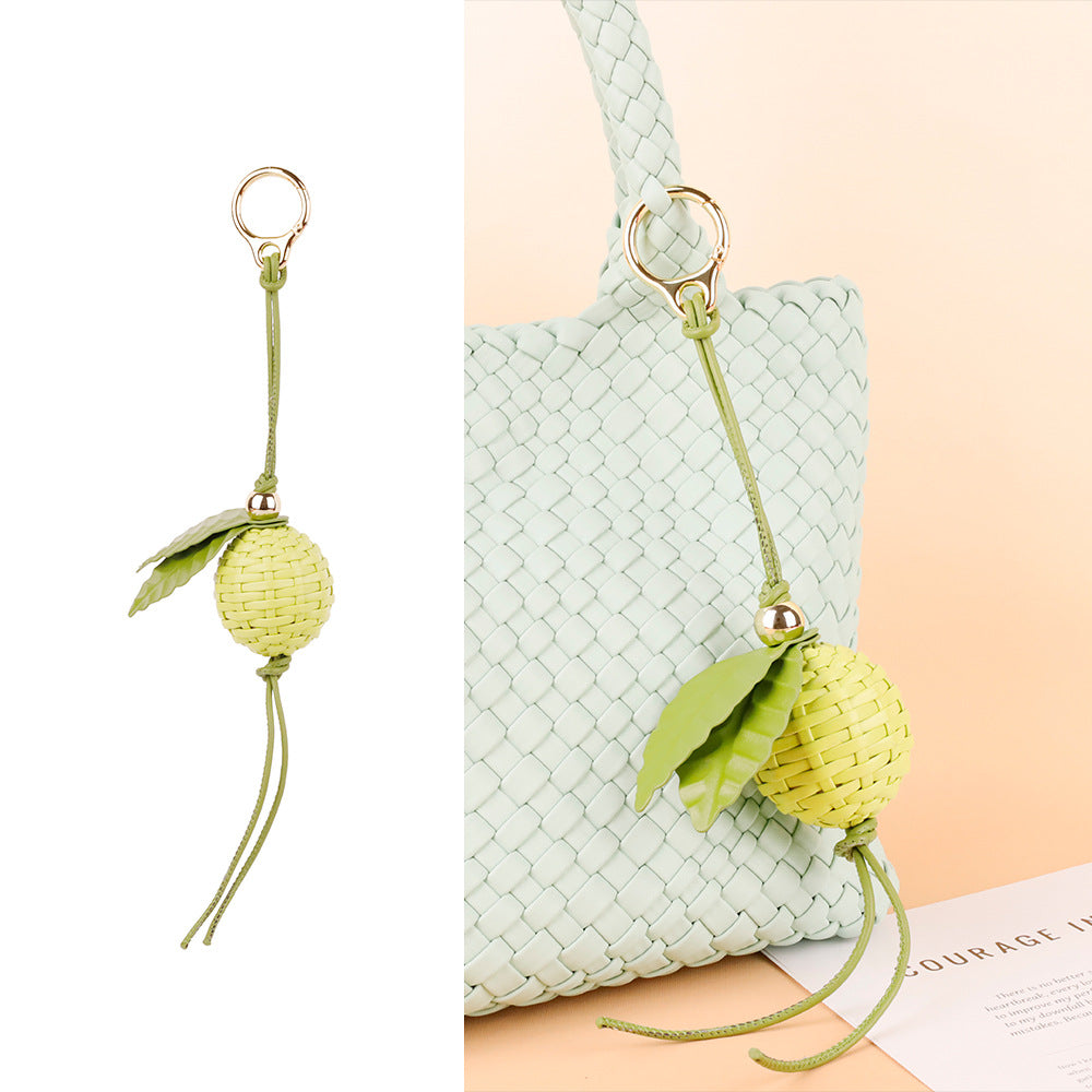 Lime green charm adding a playful touch to a tote