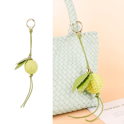 Lime green charm adding a playful touch to a tote