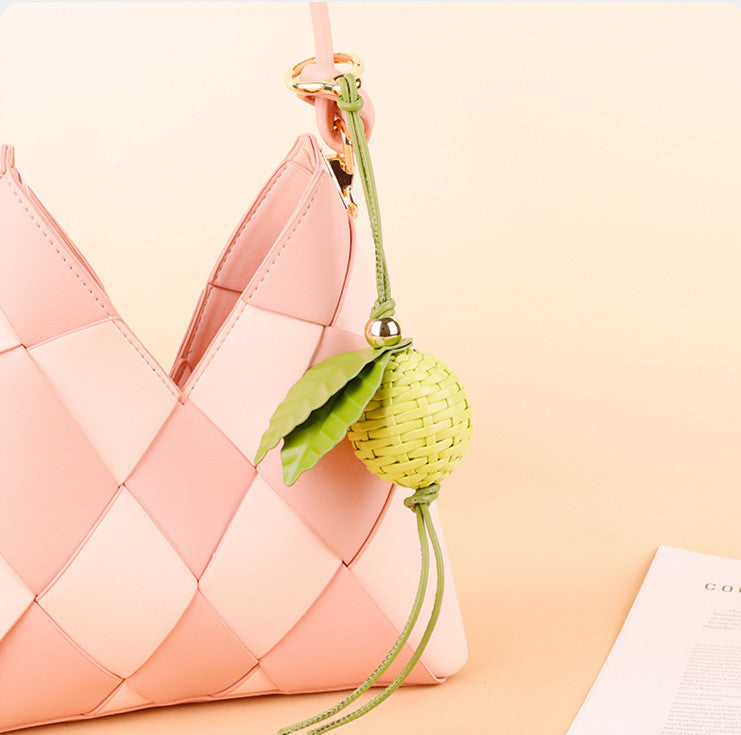Woven leaf bag accessory with a bright green finish