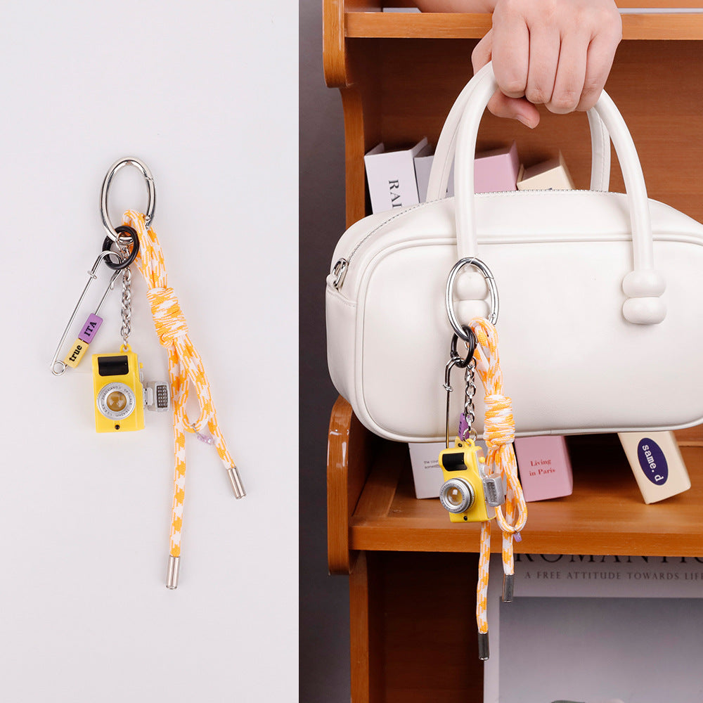 Handcrafted yellow aesthetic charm accenting a neutral tone tote bag handle