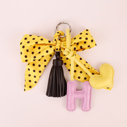 Yellow polka dot scarf detail with a soft tassel