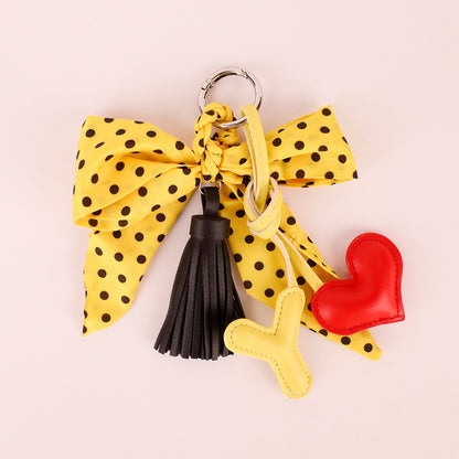 Polka dot bow charm with tassel for a handbag
