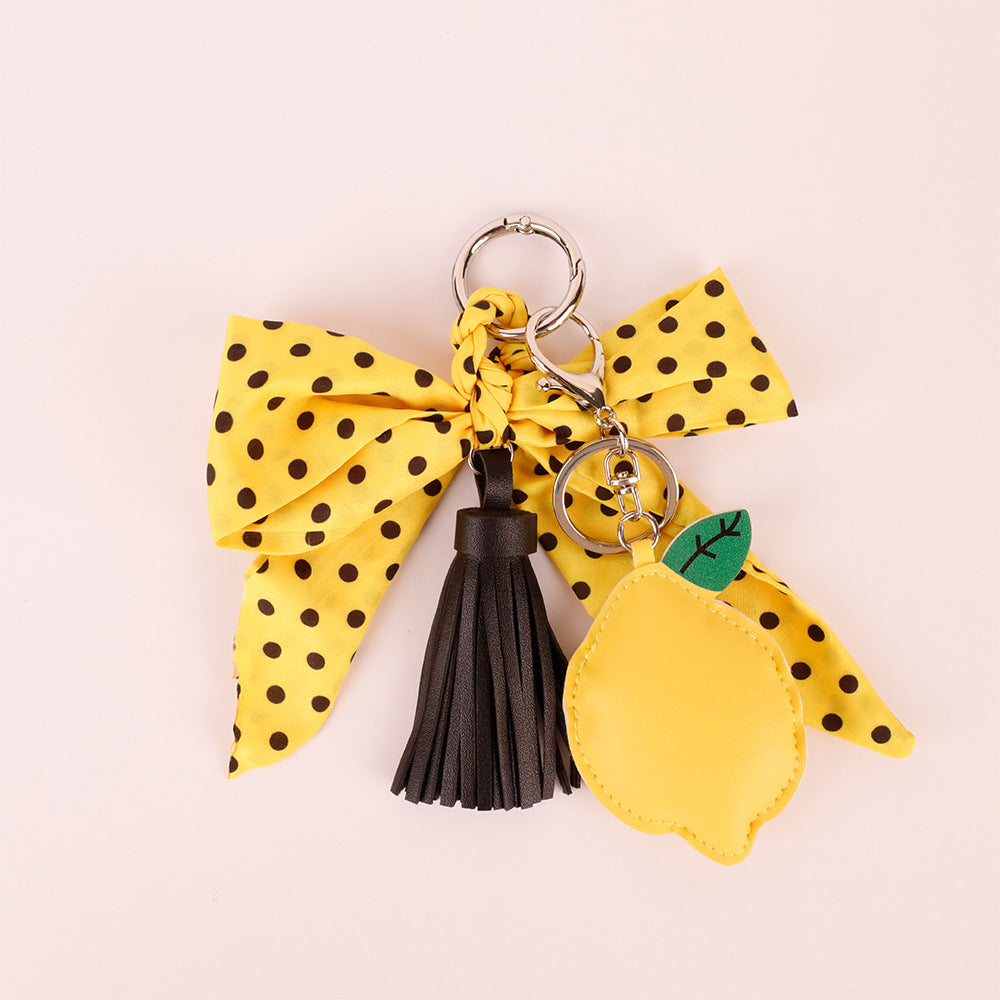 Scarf-style yellow bow charm with decorative tassel