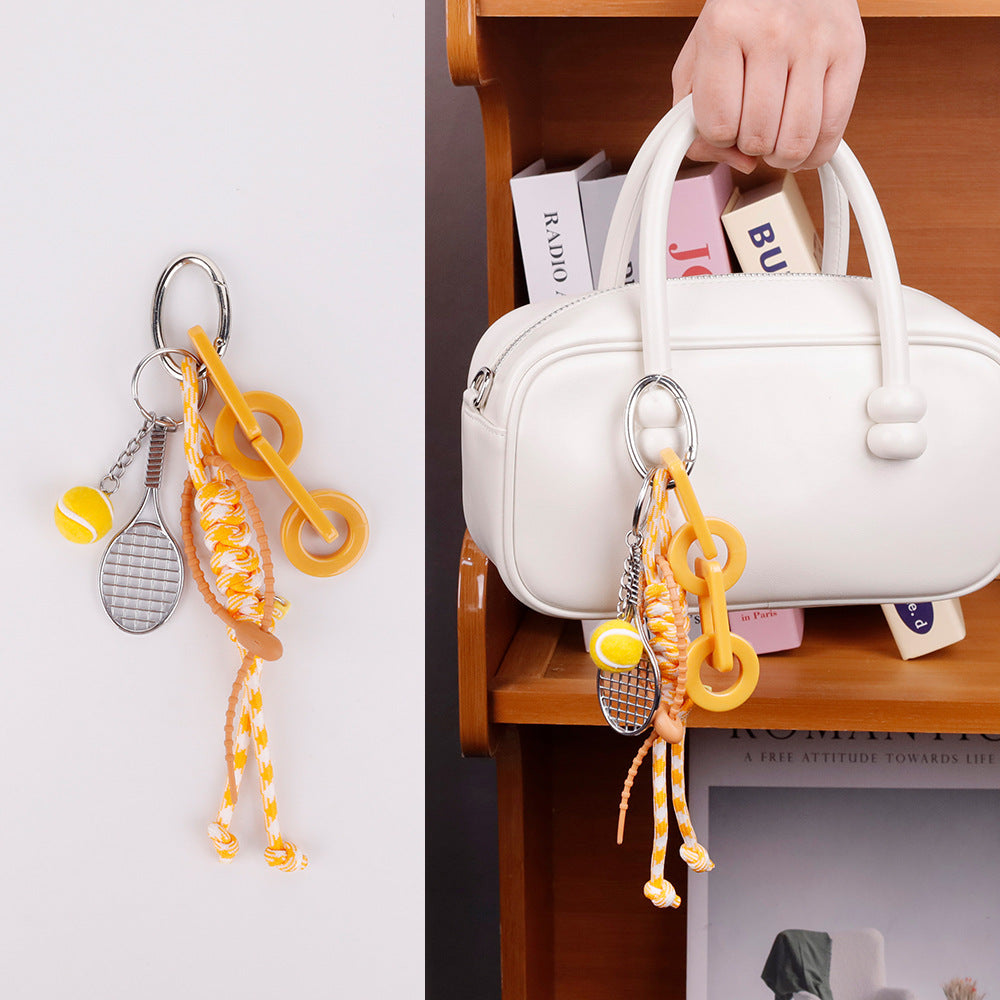 Trendy handmade yellow charm attached to a summer beach bag handle