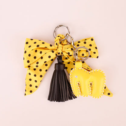 Yellow scarf bow key accessory with polka dot detail