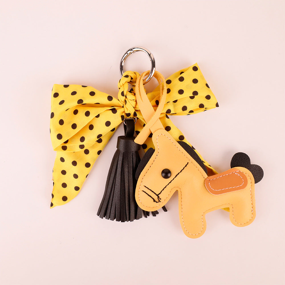 Decorative handbag charm with yellow bow and tassel