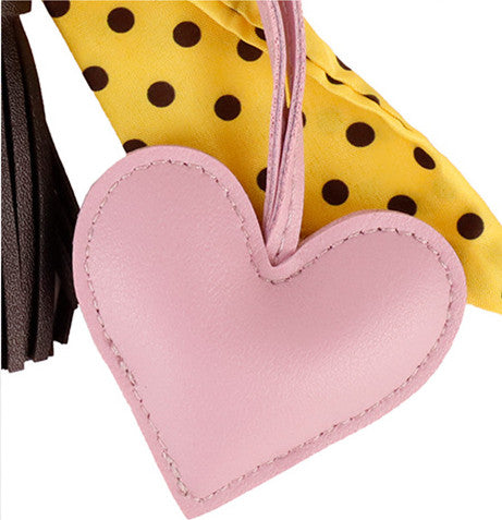 Scarf bow handbag accessory with a yellow tassel
