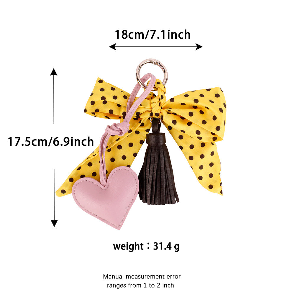 Small yellow bow accessory for bags and everyday items