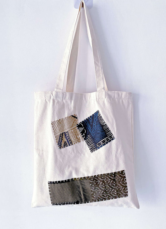 Tucking a high-capacity canvas bag into a suitcase for a conscious travel essential.