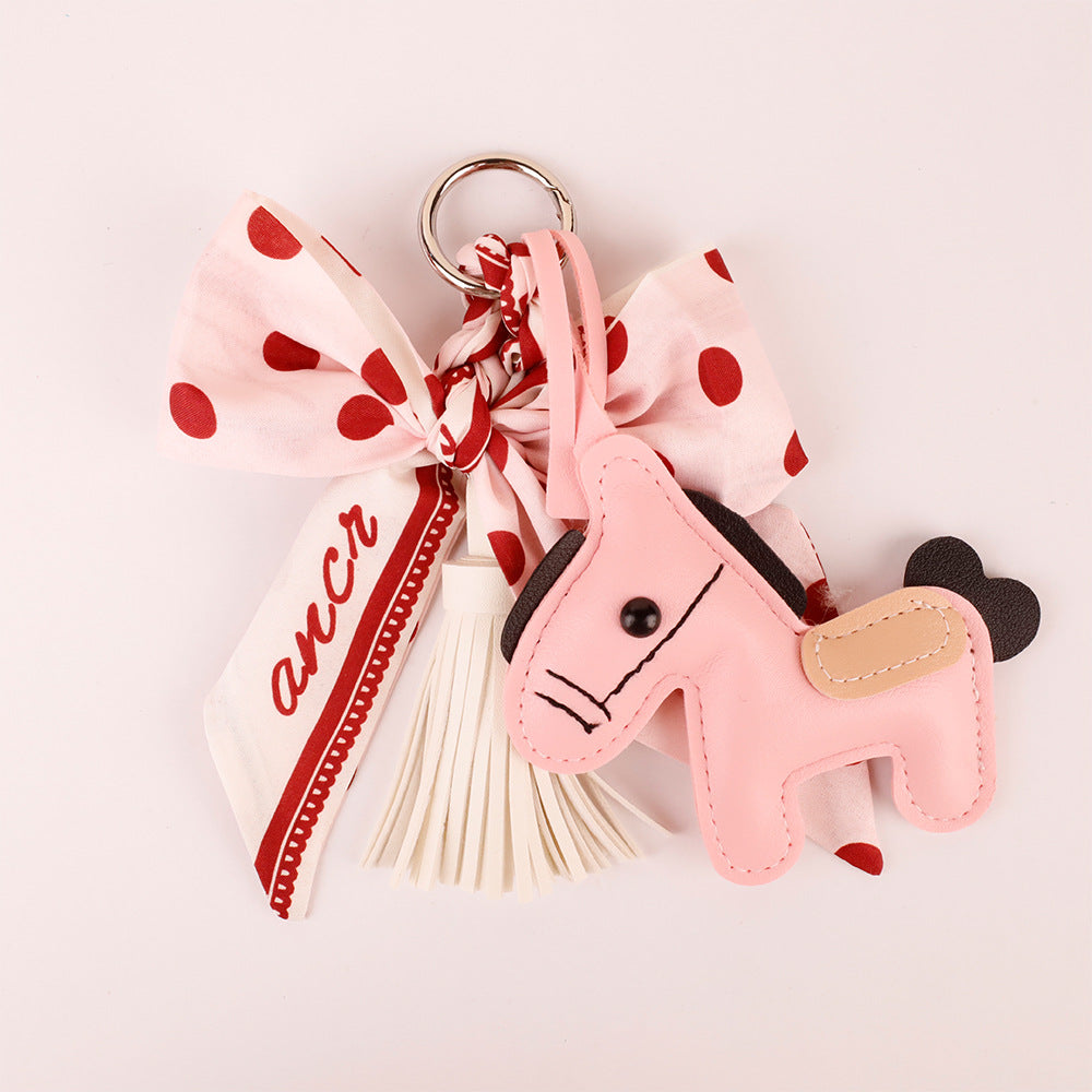 Pink scarf bow with hanging tassel accents